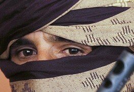 A former Taliban fighter looks on during